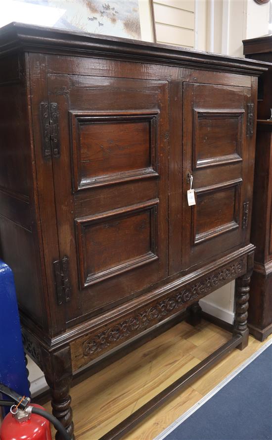 An oak two door cabinet on stand constructed from old timber W.140cm